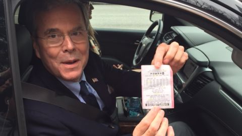 Jeb Bush shows reporters a Powerball ticket given to him by a supporter in Columbia, South Carolina, on January 9, 2016.
