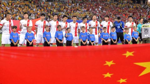 Chinese players embrace for the national anthem before during the 2015 Asian Cup match between China PR and the Australian Socceroos.