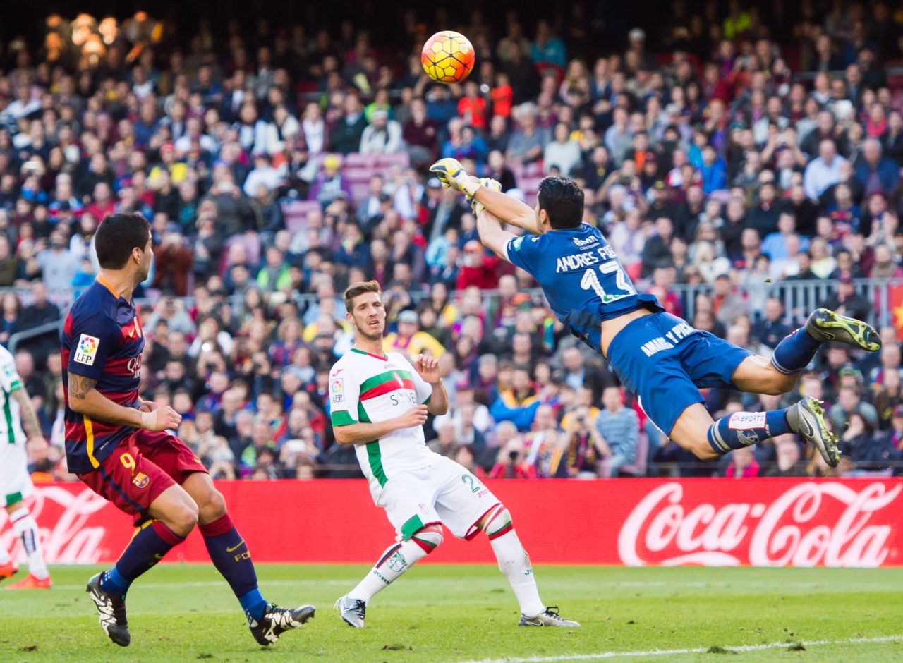 It was a tough day for Granada keeper,  Andres Fernandez of Granada CF, pictured here clearing the ball away from Luis Suarez (L) of Barcelona.