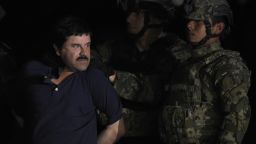 Drug kingpin Joaquin "El Chapo" Guzman is escorted to a helicopter at Mexico City's airport on January 8, 2016 following his recapture during an intense military operation in Los Mochis, in Sinaloa State. Mexican marines recaptured fugitive drug kingpin Joaquin "El Chapo" Guzman on Friday in the northwest of the country, six months after his spectacular prison break embarrassed authorities.   AFP PHOTO / ALFREDO ESTRELLA / AFP / ALFREDO ESTRELLA        (Photo credit should read ALFREDO ESTRELLA/AFP/Getty Images)