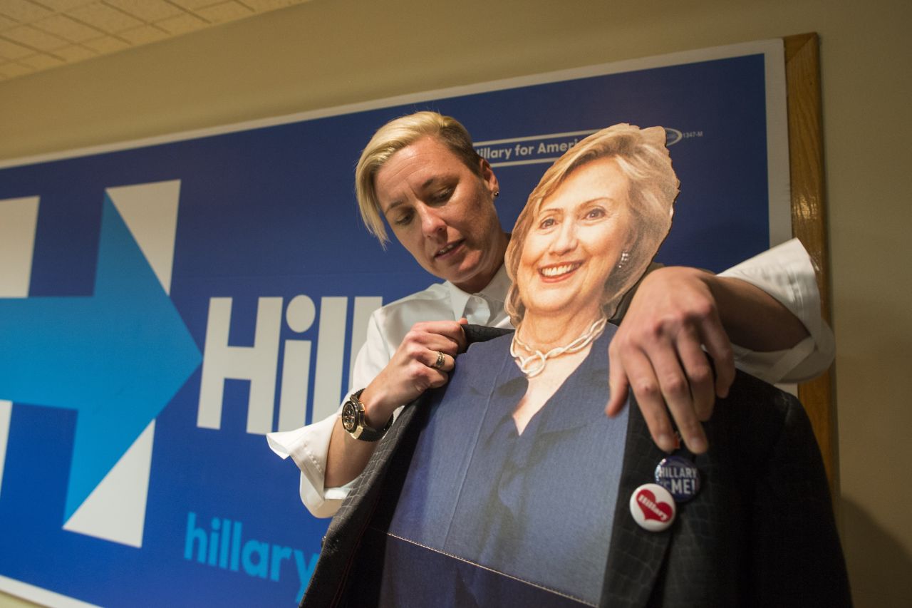 Former U.S. Women's National Soccer Team captain Abby Wambach puts her jacket on a cardboard cutout of Clinton before speaking to a crowd at a Clinton campaign office on January 8, 2016 in Salem, New Hampshire. 