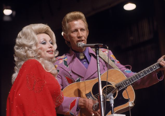 Dolly Parton turns 70 on Tuesday, January 19. The performer has had a storied singing career, both as a solo artist and in duets and groups. In fact, she essentially broke through to large audiences with Porter Wagoner, right, who gave her airtime on his TV program and recorded several duets with her. Parton wrote one of her most popular songs, "I Will Always Love You," about Wagoner. Click through the gallery for more of Parton's partners.