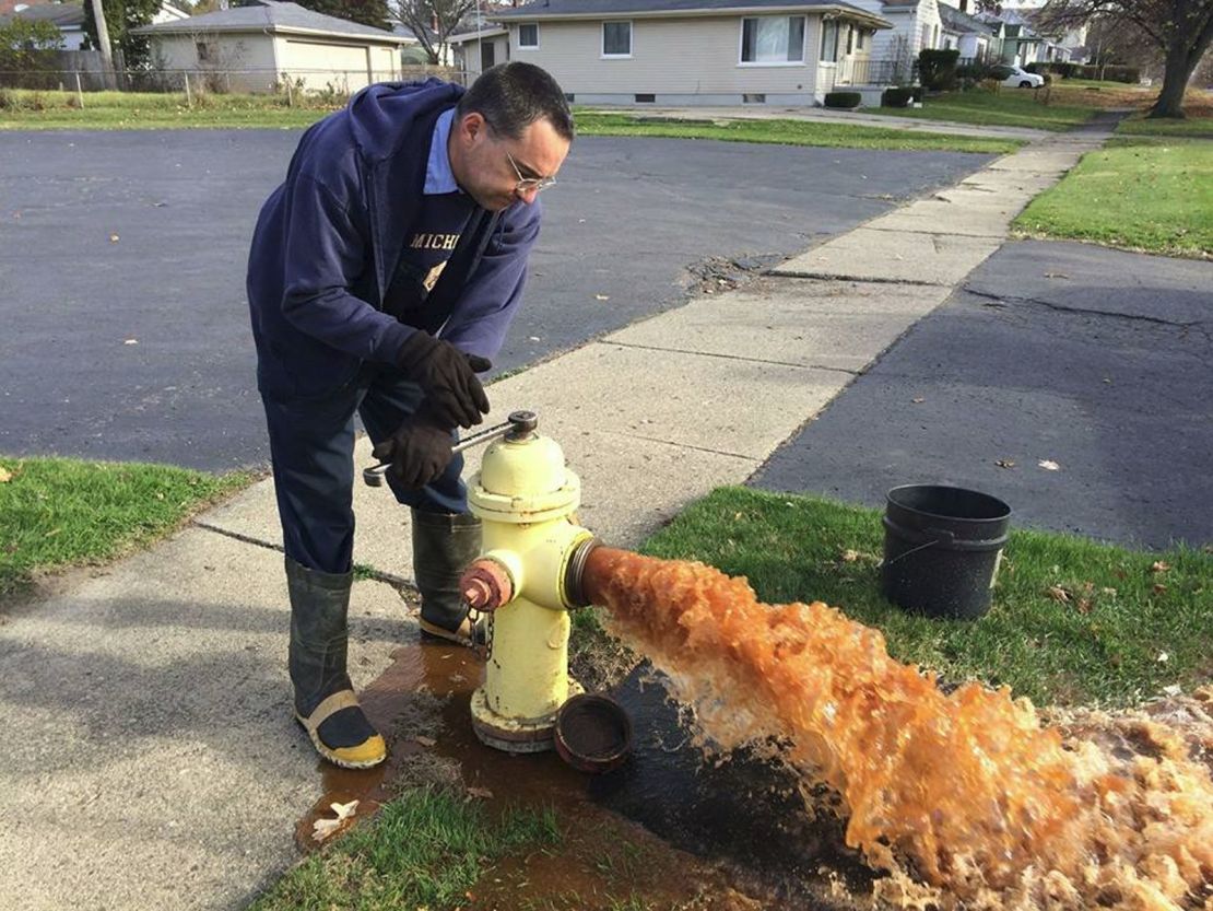 A city employee flushes out a hydrant.