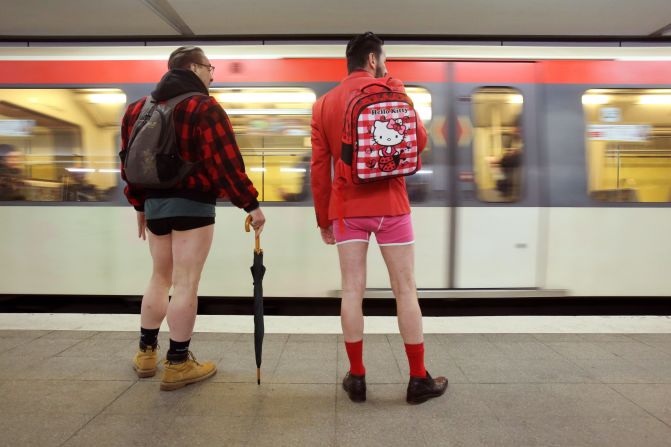 Men without pants wait for a train at a subway station in Hamburg, Germany.