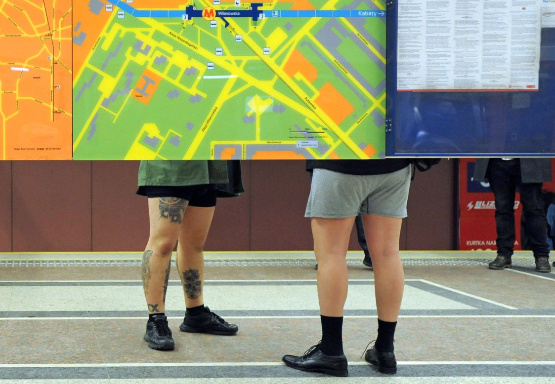 Two men wait for a train in their underwear in Warsaw, Poland.