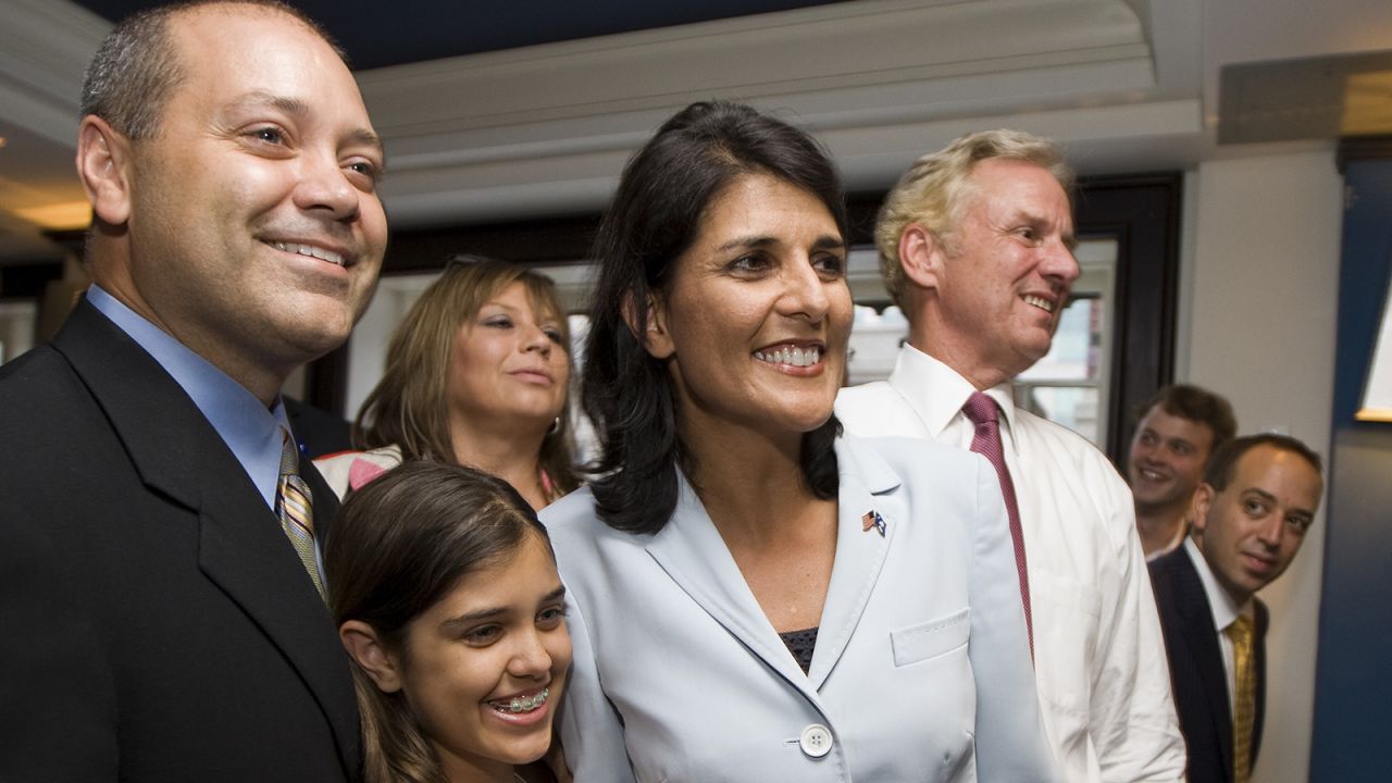 Gubernatorial candidate Nikki Haley smiles along with her husband, Michael Haley, left, and daughter Rena as they watch the Republican runoff results at the Columbia Sheraton on June 22, 2010, in Columbia, South Carolina. Haley defeated Rep. Gresham Barrett in the Republican runoff.