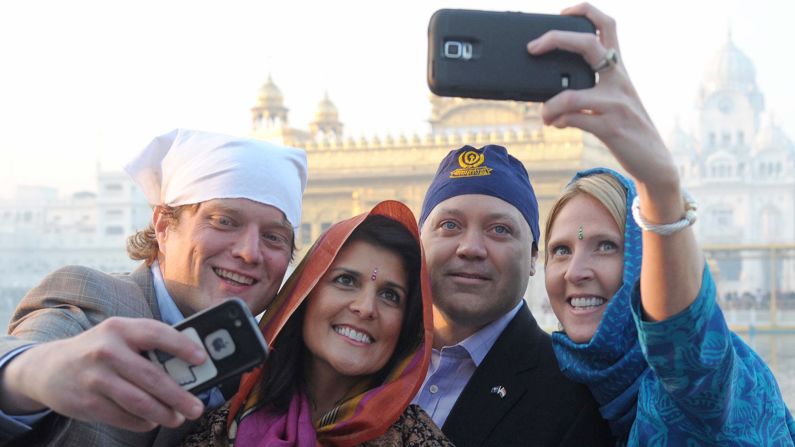 Haley and her husband pose as they take selfies at the Golden Temple in Amritsar, India, on November 15, 2014.