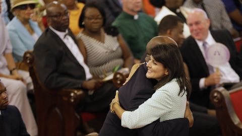 Haley hugs US Senator Tim Scott of South Carolina at Emmanuel Ame Church on June 21, 2015, four days after the mass shooting that claimed nine lives at the historic Church of Charleston.