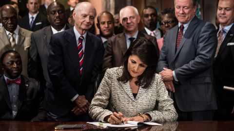 Haley signed a bill to remove the Confederate battle flag from the grounds of the State House on July 9, 2015.