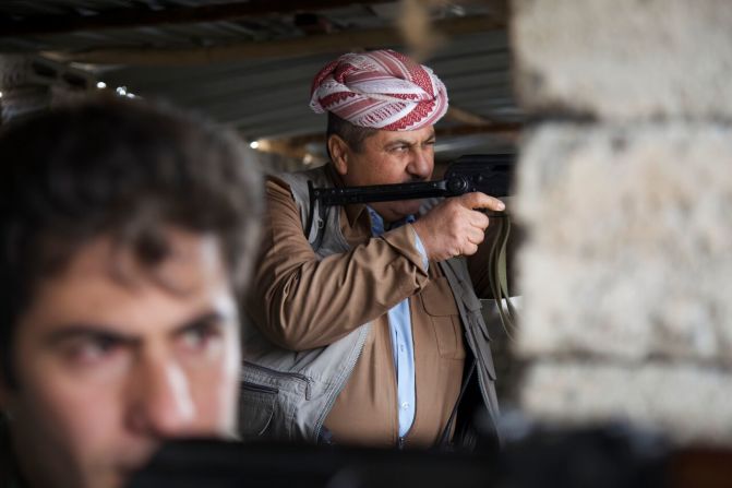 Peshmerga fighters train their guns on the front line in northern Iraq, which children try to reach after fleeing ISIS.