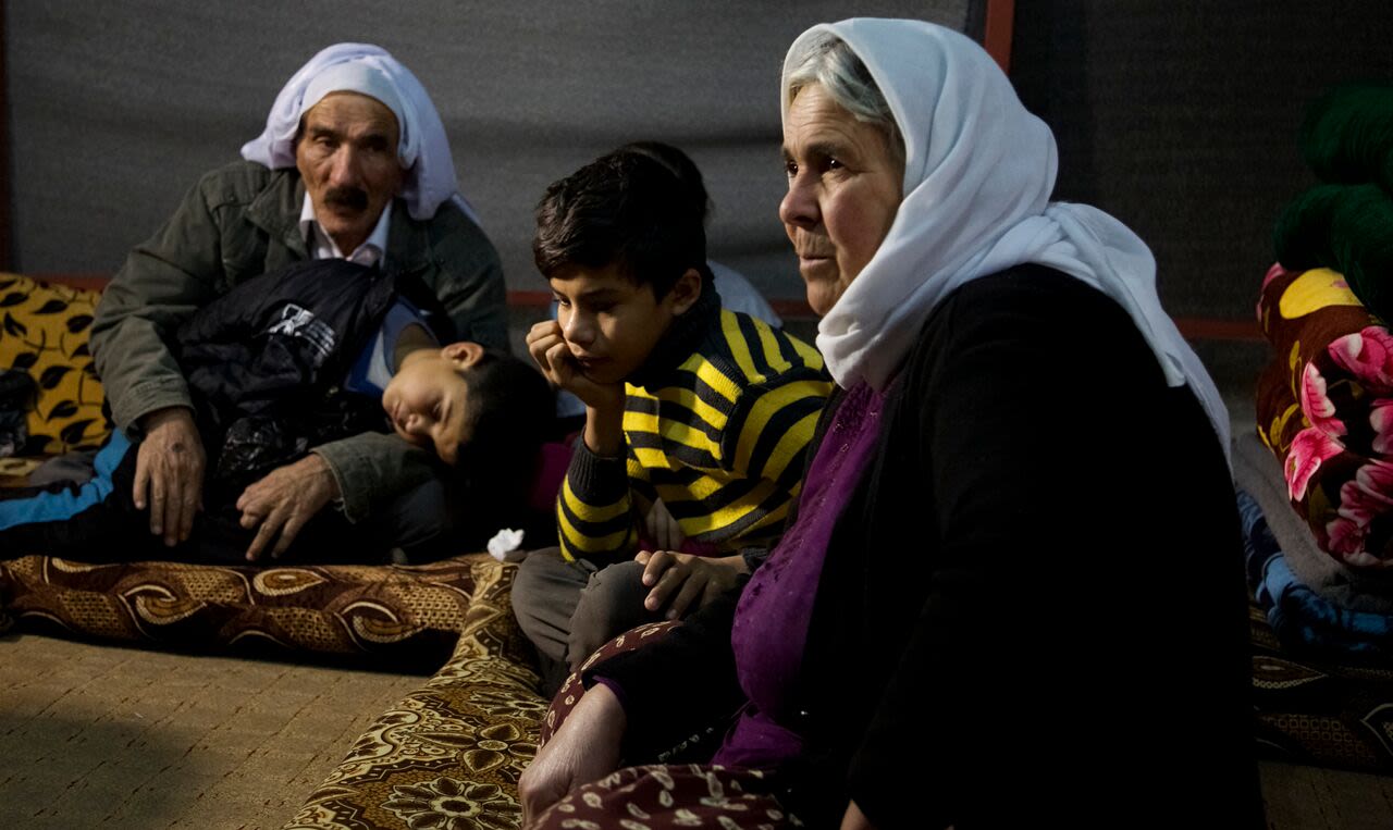 Nouri, 11, rests with his grandparents after escaping from captivity while his 5-year-old brother Saman sleeps.
