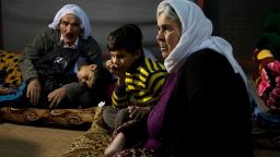 Nouri, 11, rests with his grandparents after escaping from captivity while his 5-year-old brother Saman sleeps.