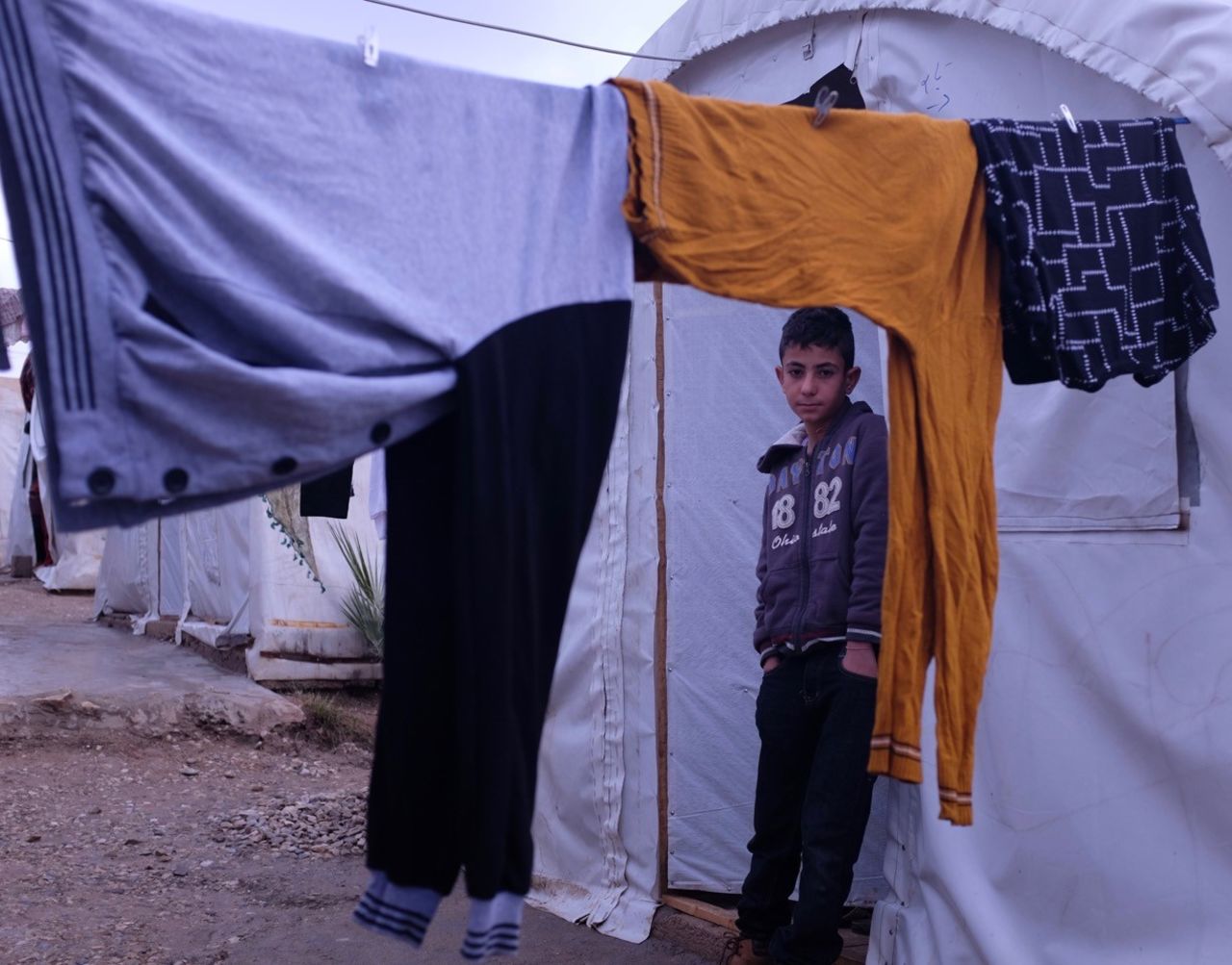 Ayman Salih, 12, pictured at the Esyan refugee camp, had been held in Mosul by ISIS at its training facility.