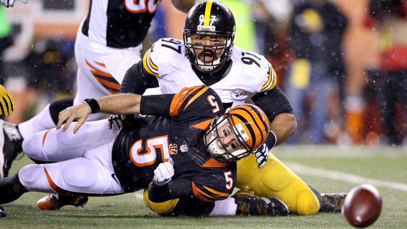 Cincinnati quarterback A.J. McCarron (No. 5) fumbles after being sacked by Pittsburgh's Cameron Heyward during an NFL playoff game in Cincinnati on Saturday, January 9. Pittsburgh won 18-16 to deny the Bengals their first playoff win in 25 years.