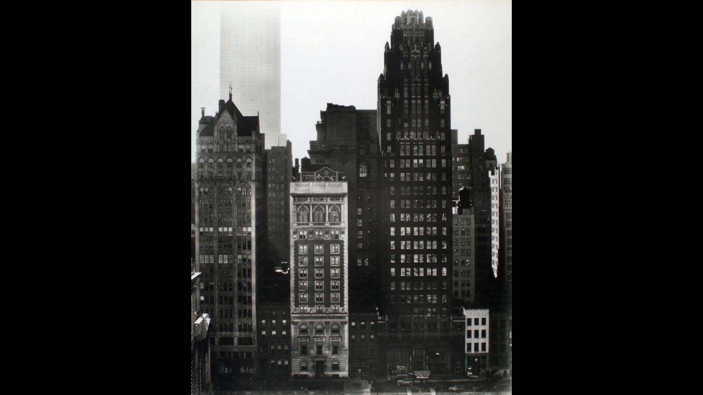 Further south, from across Bryant Park on 40th Street, Abbott photographed the Scientific American and American Radiator buildings in 1935. The Empire State Building looms in the background.