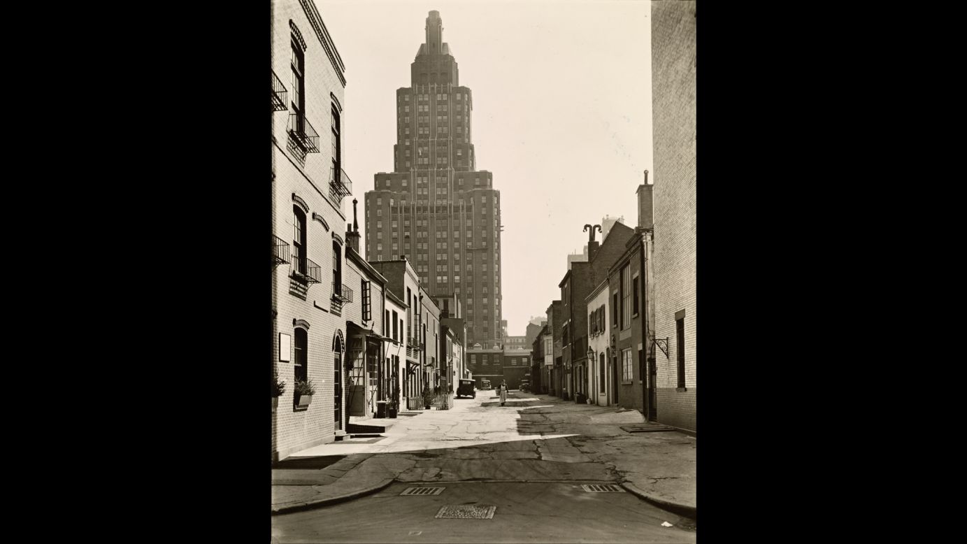 A few blocks down, between Eighth Street and Washington Square, a man in an apron walks through MacDougal Alley in 1936.