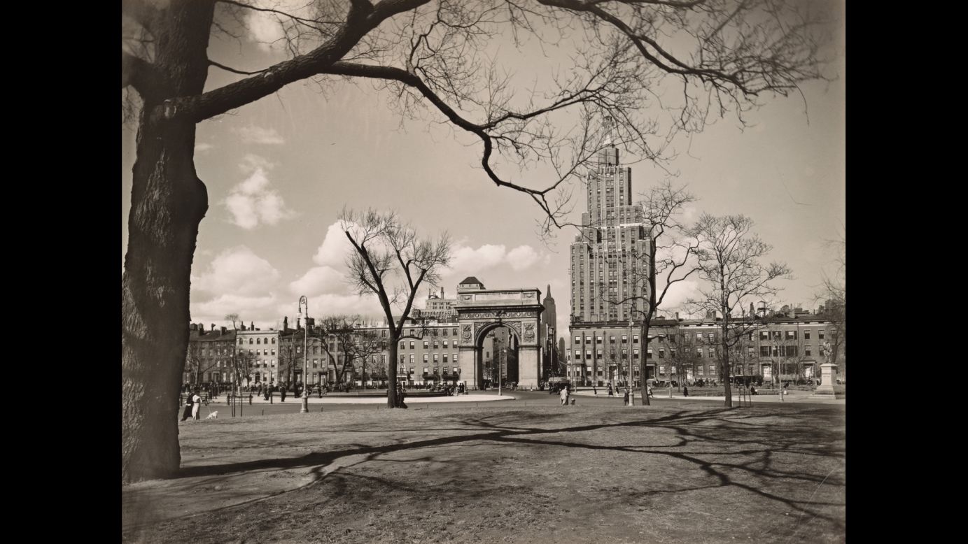 The Empire State Building is seen in the distance in this photo looking north into Washington Square in 1936.