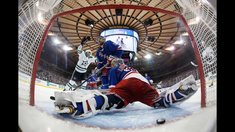 Dallas forward Patrick Sharp, left, celebrates as a shot from Antoine Roussel slips past New York Rangers goalie Henrik Lundqvist during an NHL game in New York on Tuesday, January 5. The Rangers still won the game 6-2.