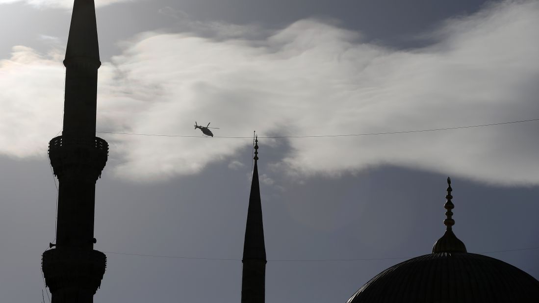 A police helicopter patrols over the historic Sultanahmet district.