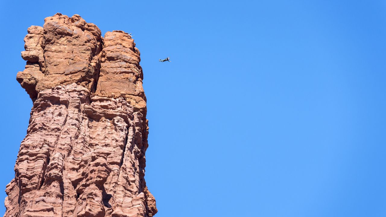 Andy Lewis jumps from the 900-foot-tall Titan Tower, the highest of the Fisher Towers, in October 2014.