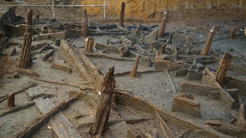 Bronze Age piles preserved within the river silts and collapsed structural timbers.