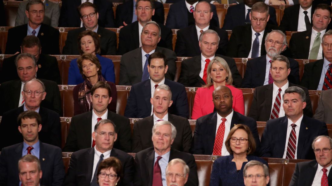 Members of Congress, including Republican presidential candidate Sen. Marco Rubio, center, listen.