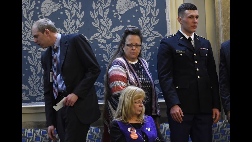 Kim Davis (C), the Rowan County clerk in Kentucky, arrives before US President Barack Obama delivers the State of the Union Address during a Joint Session of Congress at the US Capitol in Washington, DC, January 12, 2016. Kim Davis, a born-again Christian, was jailed briefly in September 2015 for contempt of court after refusing to issue marriage  licenses due to her opposition to gay marriage, which the Supreme Court legalized across the United States in June. Barack Obama will give his final State of the Union address, perhaps the last big opportunity of his presidency to sway a national audience and frame the 2016 election race. AFP PHOTO / SAUL LOEB / AFP / SAUL LOEB        (Photo credit should read SAUL LOEB/AFP/Getty Images)