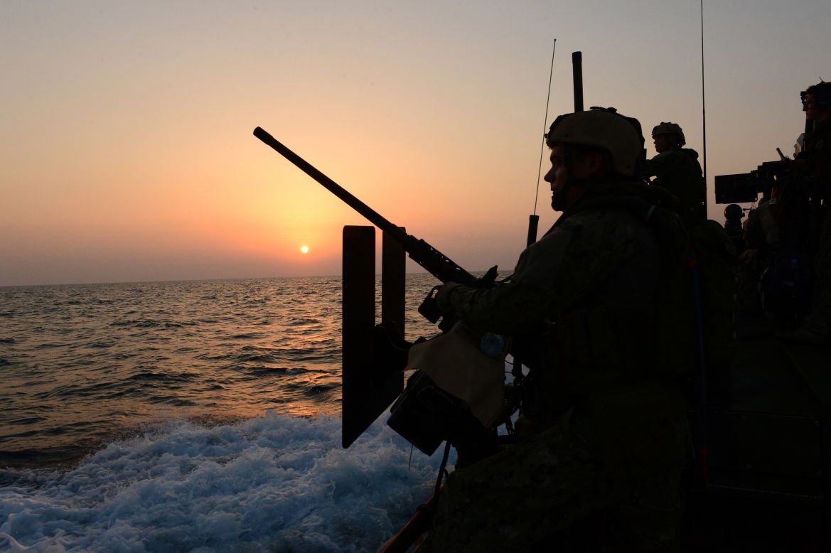 Sailors ride a riverine command boat in the Gulf in October 2012.