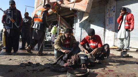 Pakistani security officials examine the site of a blast near a polio vaccine center in Quetta on Wednesday.