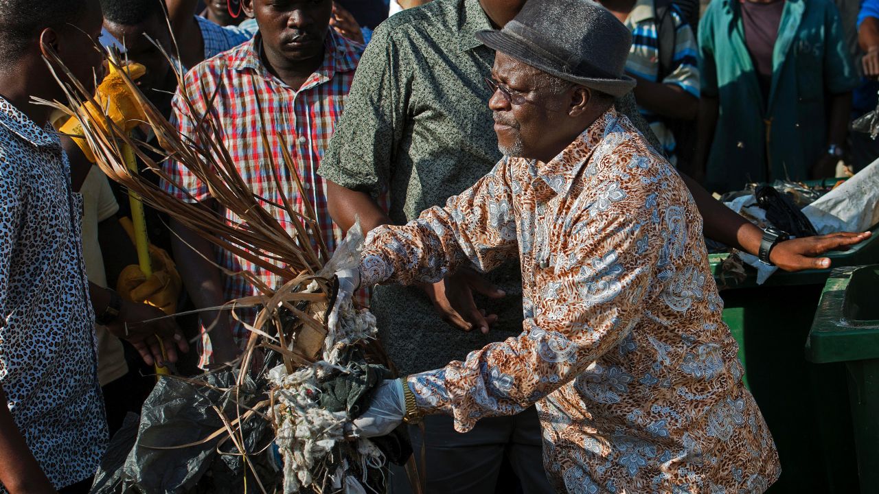 Tanzanian President John Magufuli joins a clean-up event outside the State House in Dar es Salaam on December 9, 2015 - Independence Day. 