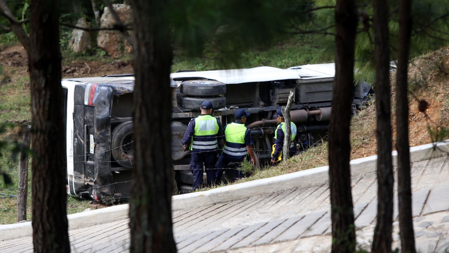 A  bus rests on its side Wednesday between San Juancito and the Honduras capital of Tegucigalpa.