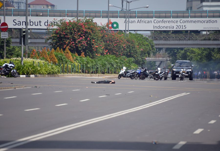 A body lies in the middle of the street near a damaged police post on January 14.