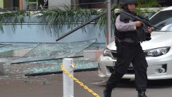 An Indonesian anti-terror policeman walks next to the Starbucks cafe after several blasts and shootings in Jakarta on January 14, 2016. 
Gunfire and explosions in the Indonesian capital Jakarta killed at least six people on January 14 in what the country's president dubbed "acts of terror", with fears that militants were still on the run. Starbucks announced in a statement that the company was closing all of its Jakarta branches "until further notice" after one of its stores in the Indonesian capital was hit by apparent suicide attacks.  / AFP/AFP/Getty Images
