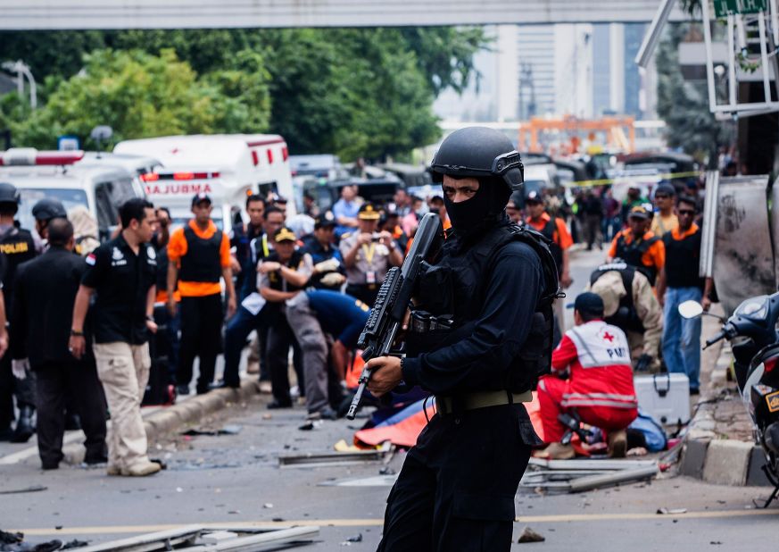 A policeman stands guard in front of a blast site in central Jakarta after a series of explosions rocked the heart of the Indonesian capital on Thursday, January 14.