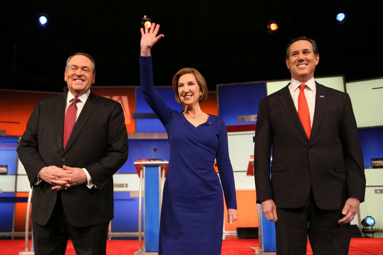 From left, Republican presidential candidates Mike Huckabee, Carly Fiorina and Rick Santorum arrive for the "undercard" debate that took place a couple of hours before the main event.