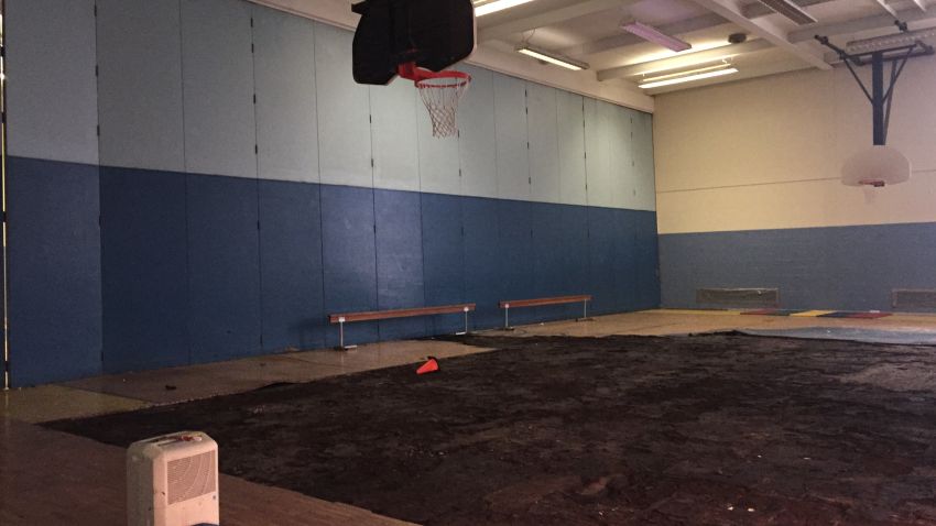 Part of the warped floor was pulled up but never replaced, leaving kids without a gym.