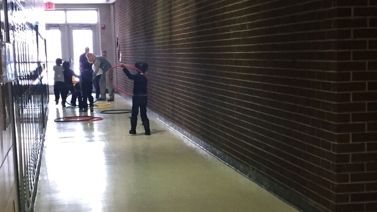 Children play in the hallway because the gym and the playground are closed.