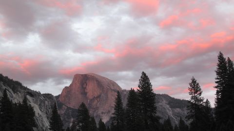 A view of Half Dome from Cook's Meadow at Yosemite National Park shows the colors at sunset.
