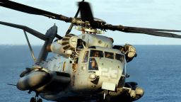 A CH-53E Super Stallion helicopter lands on the flight deck of the amphibious assault ship USS Peleliu.
