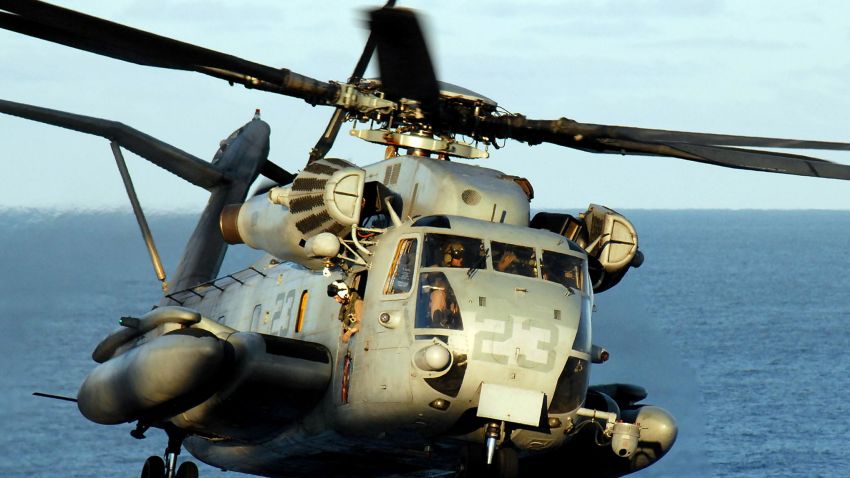 A CH-53E Super Stallion helicopter lands on the flight deck of the amphibious assault ship USS Peleliu 