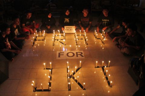 Students light candles to express solidarity for those affected by the deadly attack in Jakarta during a vigil on January 14 in Surabaya, East Java, Indonesia.