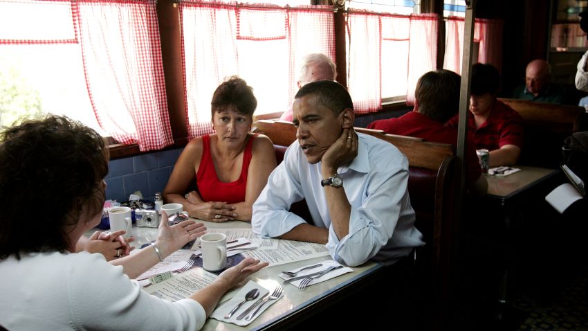 Then-Democratic presidential hopeful, U.S. Sen. Barack Obama, D-Ill., right, listens to Donna Richardson, left, of Concord during a quick stop at the Tumble Inn diner where he met with patrons and ordered a cheeseburger to go in Claremont, N.H., on Monday, Aug. 13, 2007.