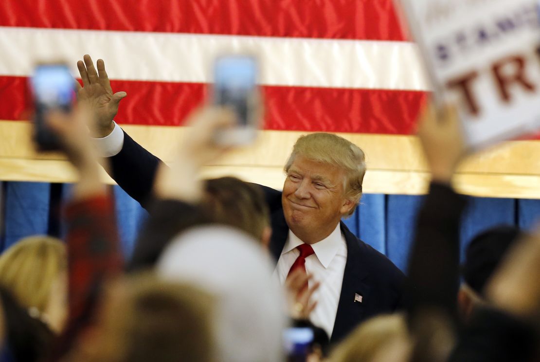 Republican presidential candidate Donald Trump waves as he arrives at a campaign stop at the White Mountain Athletic Club on Tuesday, Dec. 1, 2015, in Waterville Valley, N.H. 
