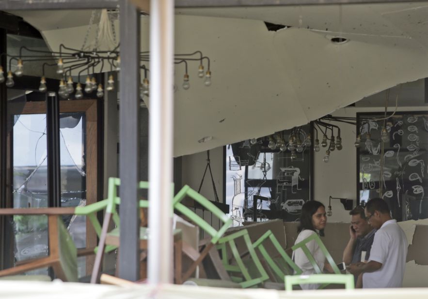 Employees inspect the damage on January 15, 2016 at the Starbucks cafe where deadly attacks occurred the day before in central Jakarta, Indonesia. ISIS claimed responsibility for the attack in an official statement posted online.