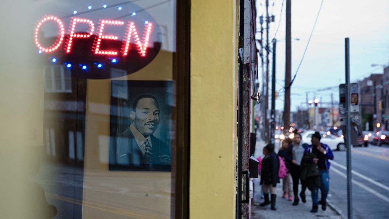 A portrait of the Rev. Martin Luther King Jr. looks out from a restaurant window on Edgewood Avenue one block south of historic Auburn Avenue. Revitalization has taken hold quicker on Edgewood than on Auburn, though some call the development gentrification.