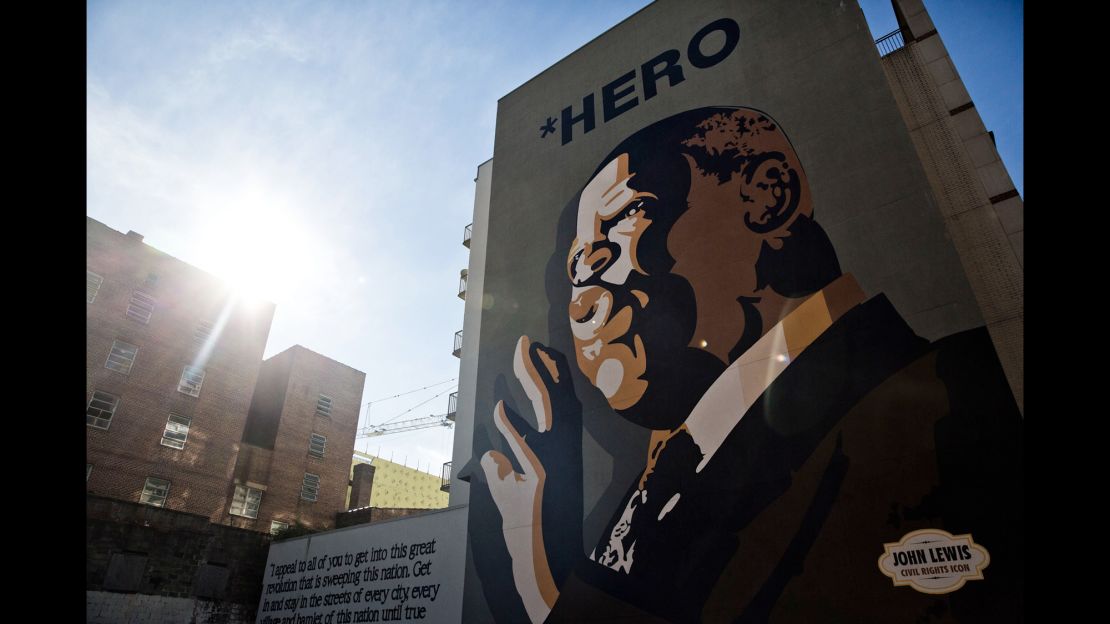 A mural of Congressman John Lewis stands over Jesse Hill Jr. Drive and Auburn Ave in Atlanta.