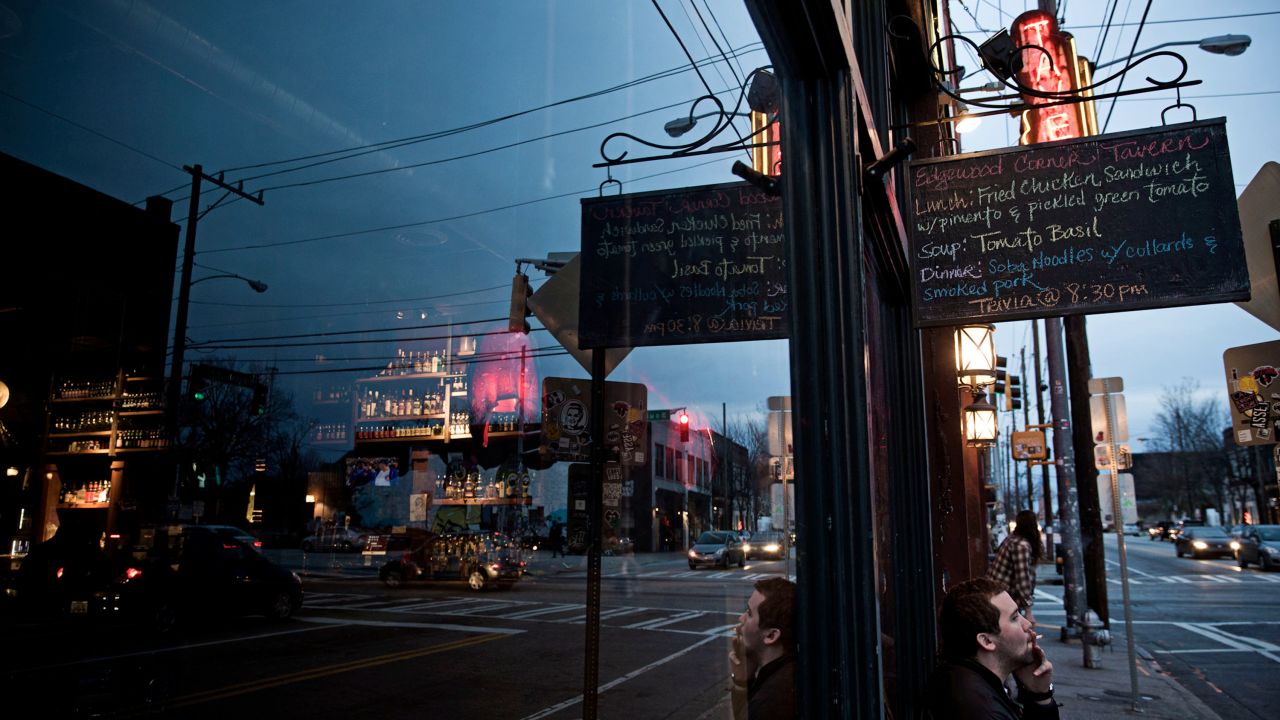 As the sun sets, foot traffic begins to pick up on Edgewood Avenue, one block away from Auburn Avenue. Over the past decade, boarded-up storefronts have transformed into bars and restaurants as more young residents have moved to the inner city.