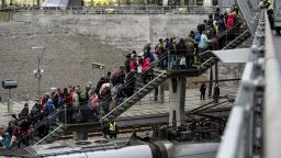 Police organize the line of refugees on the stairway leading up from the trains arriving from Denmark at the Hyllie train station outside Malmo, Sweden, November 19, 2015. 600 refugees arrived in Malmo within 3 hours and the Swedish Migration Agency said in a press statement that they no longer can guarantee accommodation for all asylum seekers.     AFP PHOTO / TT NEWS AGENCY / JOHAN NILSSON    +++   SWEDEN OUT   +++        (Photo credit should read JOHAN NILSSON/AFP/Getty Images)