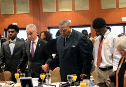 Chicago Mayor Rahm Emanuel, second from left, and the Rev. B. Herbert Martin, second from right, say a prayer during the breakfast.