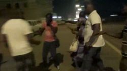 In this image taken from video from AP Television, plain-clothed policemen leading people away near the Splendid Hotel, Friday, Jan. 15, 2016, in Ouagadougou, Burkina Faso. The SITE Intelligence Group reports that an al-Qaida affiliate is claiming responsibility for the ongoing siege on an upscale hotel and cafe in Burkina Faso's capital where an unknown number of hostages are being held. (AP Television via AP)